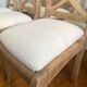 Set of 6 cross-back chairs in solid wood, with white boucle seats.