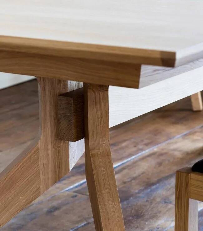 Wooden dining table with a cross extension.