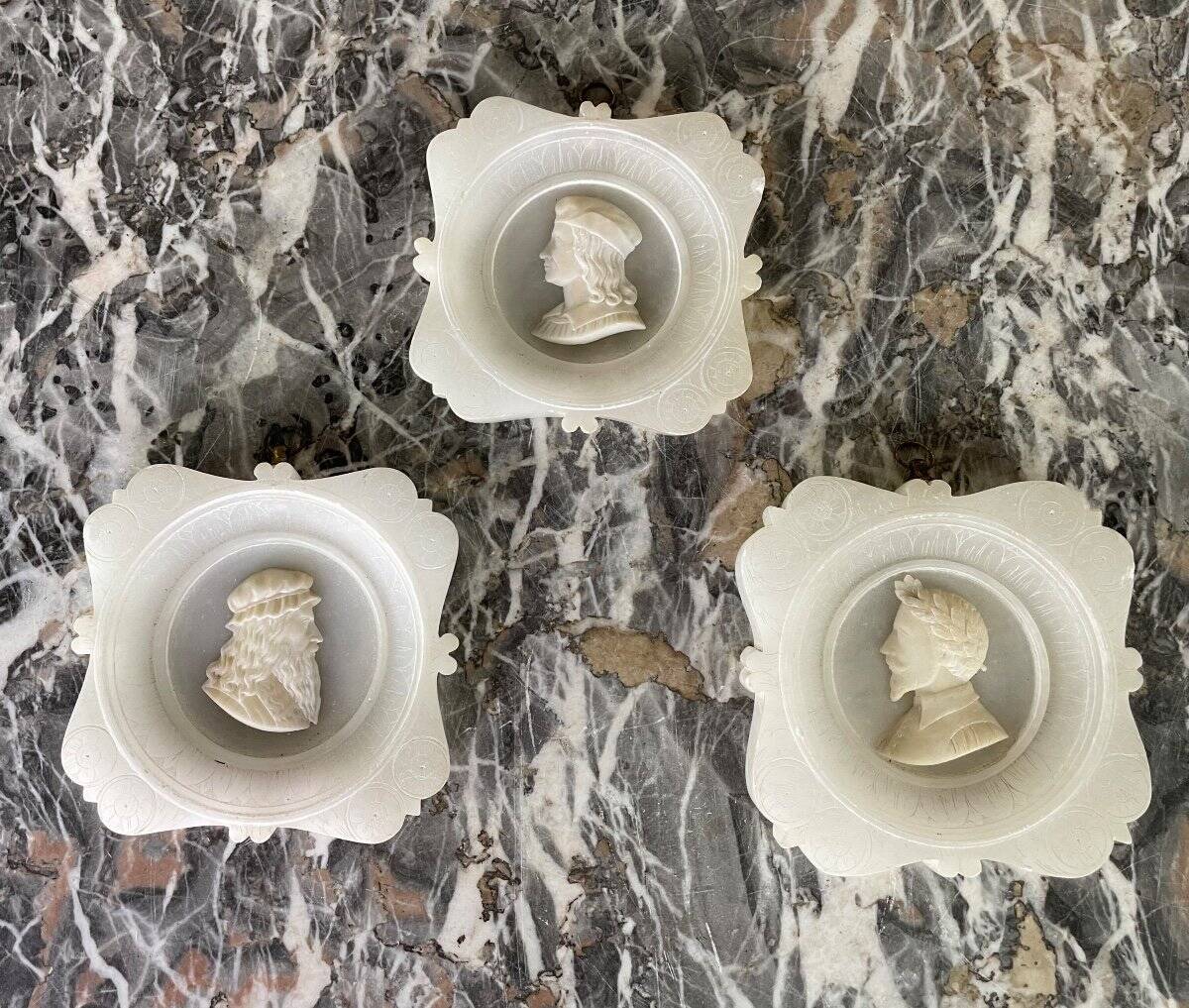 Three alabaster profiles of men, Italy around 1880