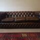 Vintage three-seater brown leather Chesterfield sofa