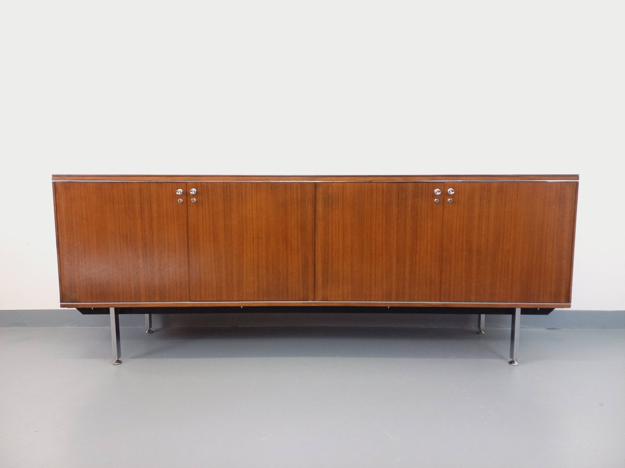Vintage modernist enfilade in rosewood and chrome metal from the 60s and 70s.