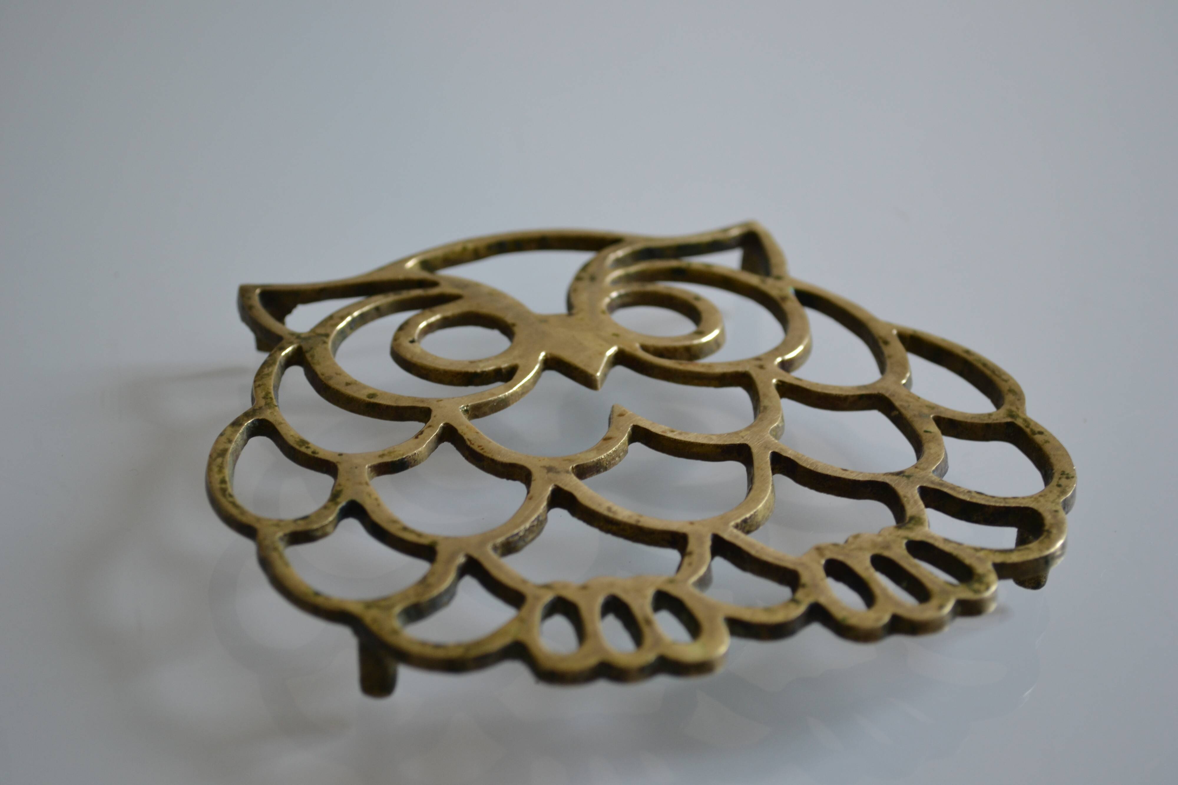 Vintage openwork brass trivet in the shape of an owl or owl