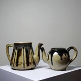 A pair of small vintage teapots in the Art Deco style reminiscent of Denbac.