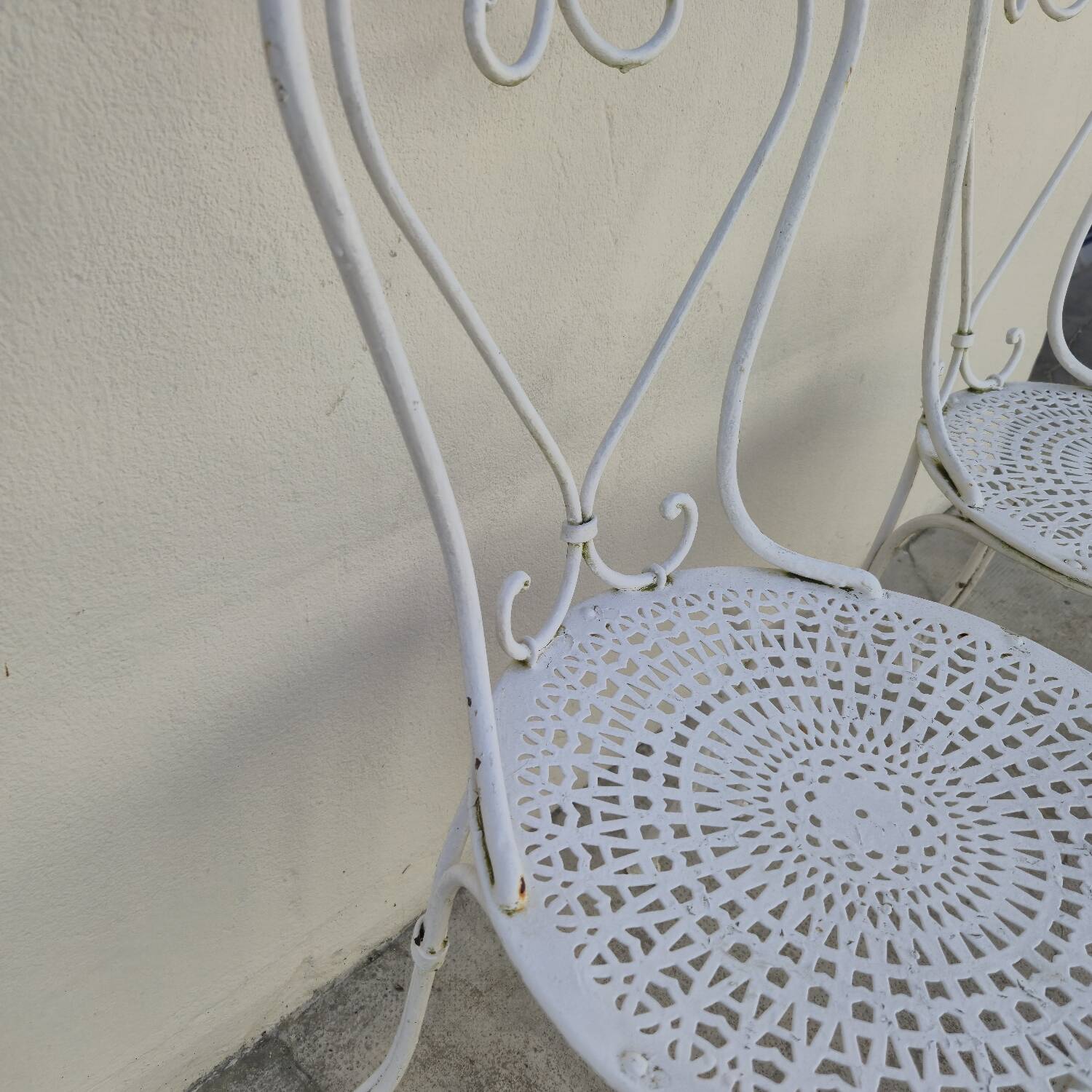 Pair of wrought iron garden chairs, antique manufacture