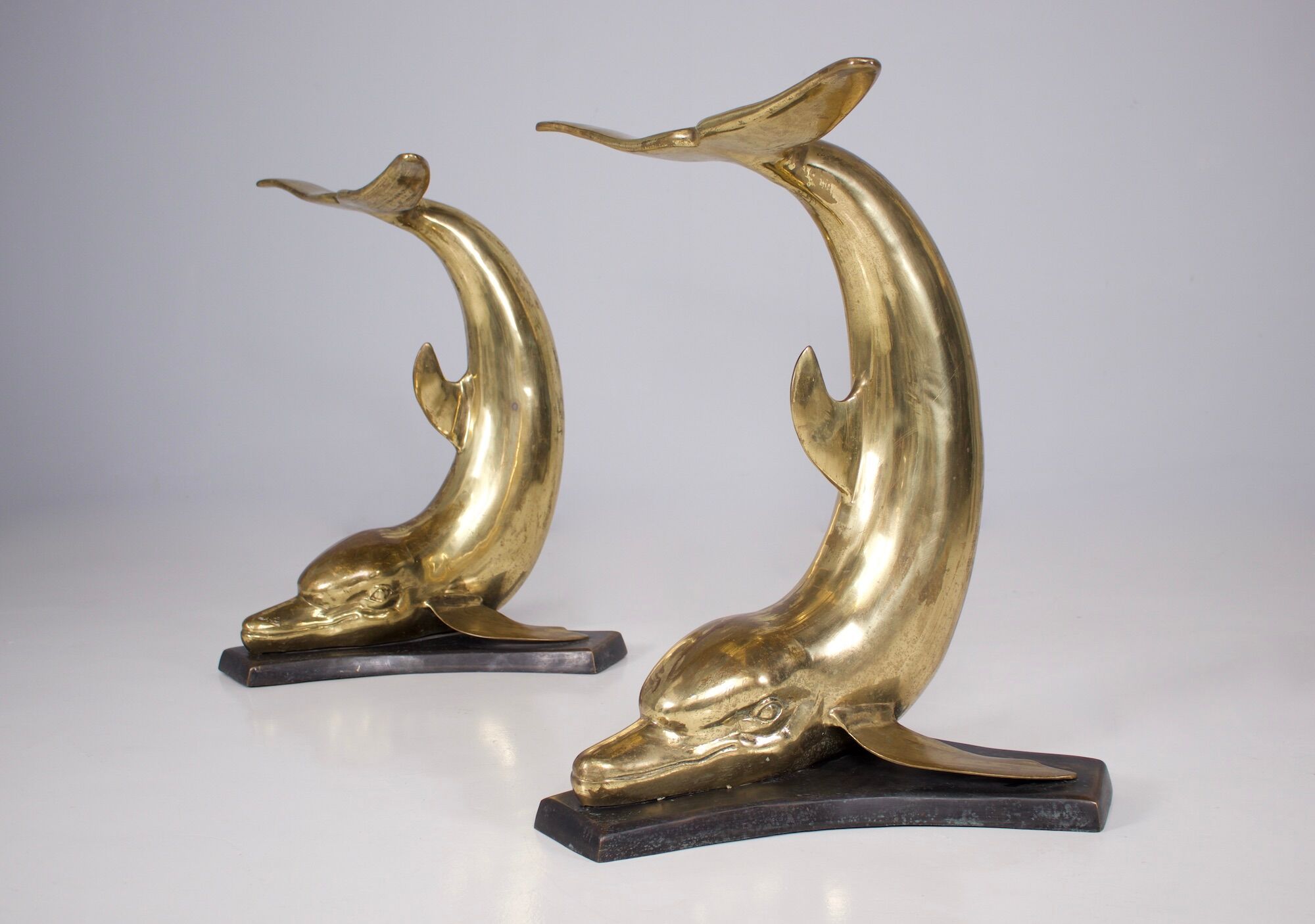 Solid brass dolphin console feet.