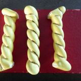 12 yellow and gold ceramic knife rests in their case from the 1950s.