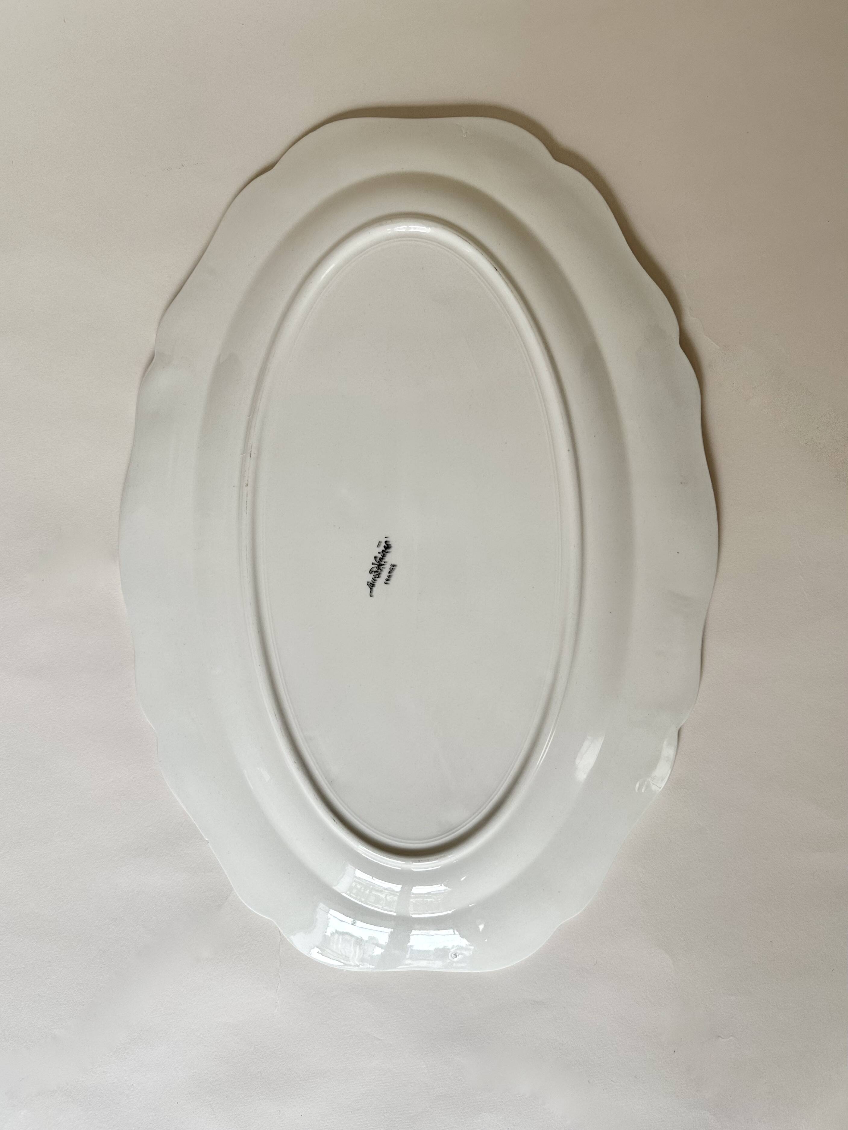 Shaped plates and dishes in Sarreguemines earthenware.