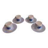 Set of four coffee cups with plates