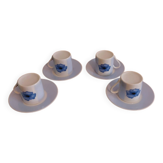 Set of four coffee cups with plates