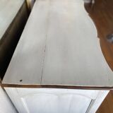 Patinated crossbow chest of drawers.