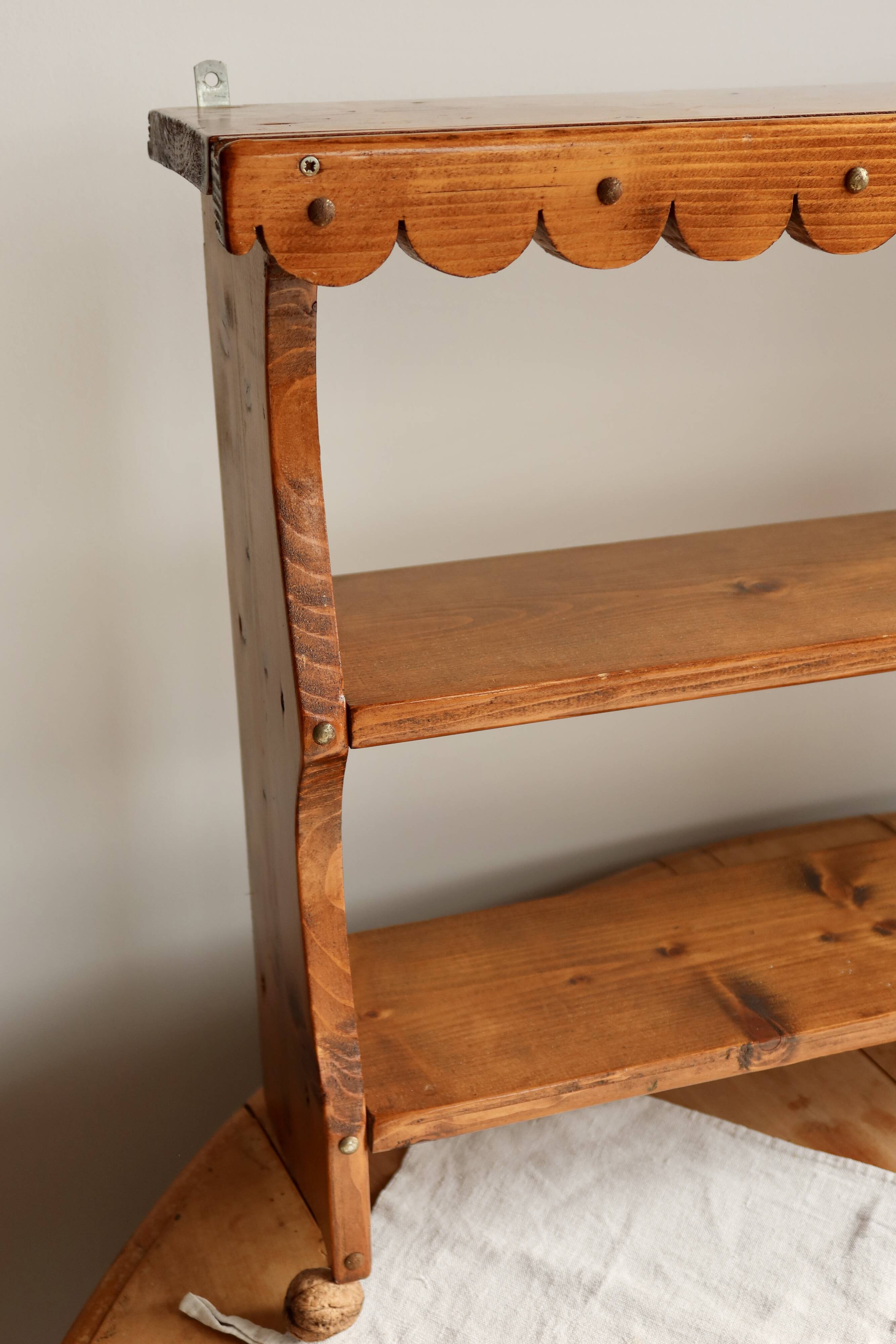 Vintage pine wall shelf with a scalloped front.