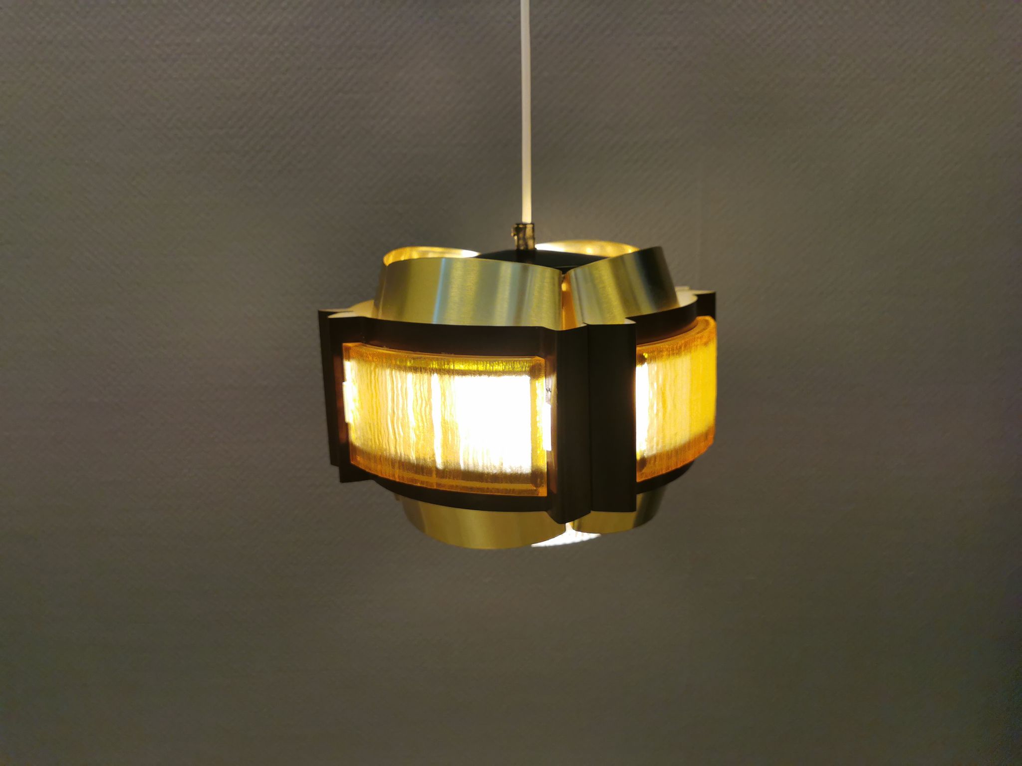Danish hanging lamp, made in brass colored and brown metal, with yellowish hard pressed plastic deta