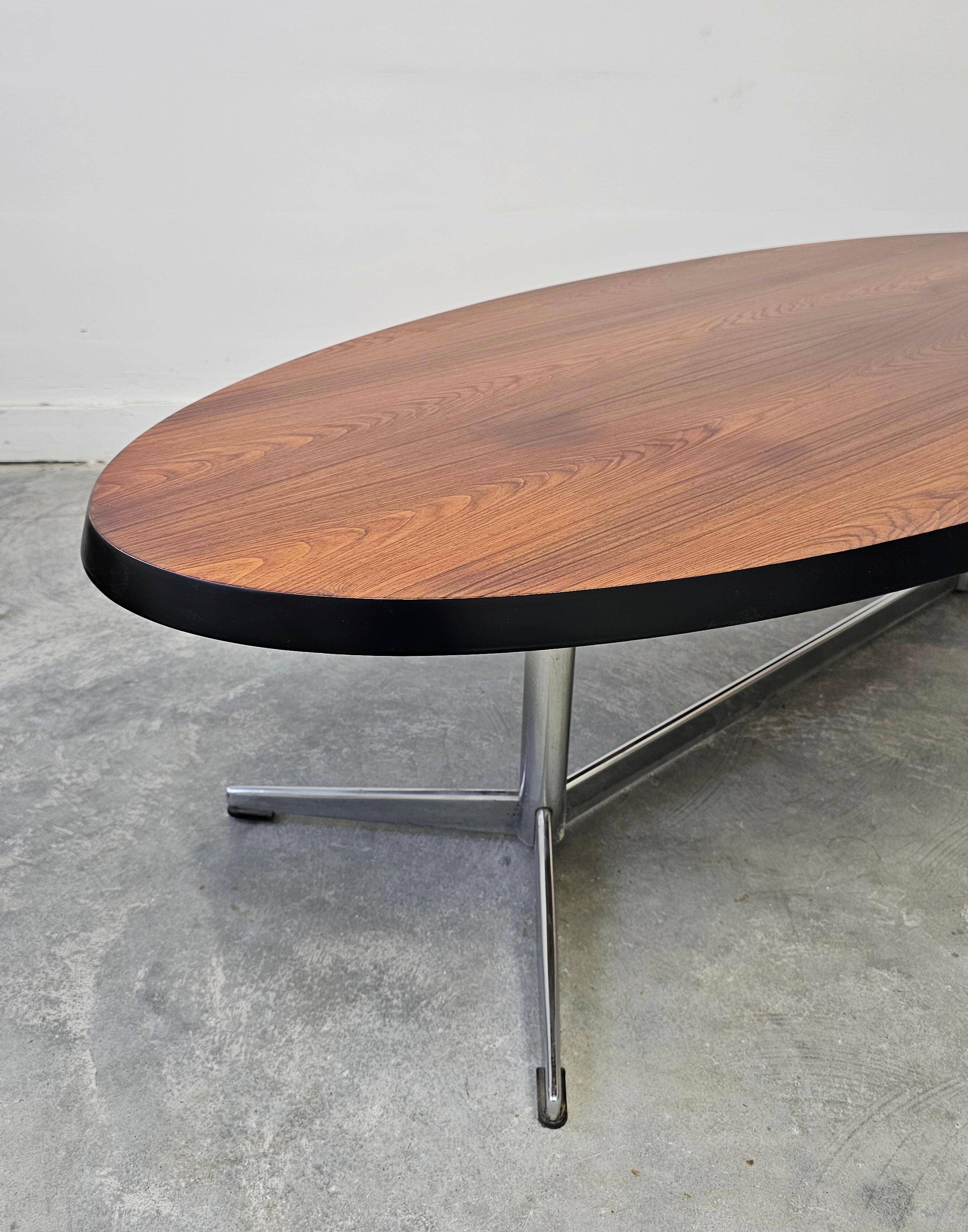Danish Mid Century Modern oval coffee table with a teak top and chrome legs.