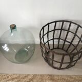 Old demijohn and her metal basket