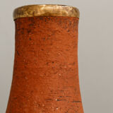 Old terracotta and brass bottle