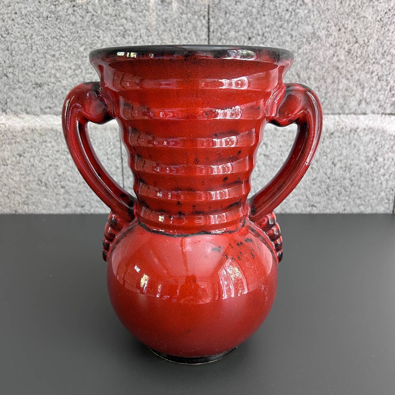Red vase with floral decoration
