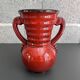 Red vase with floral decoration