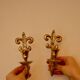 A pair of antique brass wall sconces.