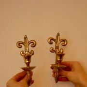 A pair of antique brass wall sconces.