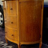 Half-moon commode in burl wood with a marble top.