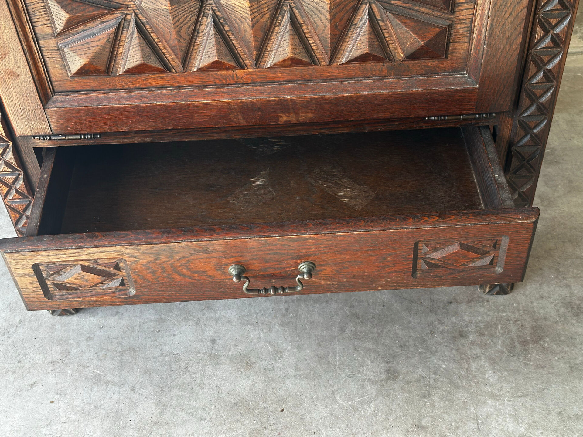Small storage cabinet in carved oak – circa 1930