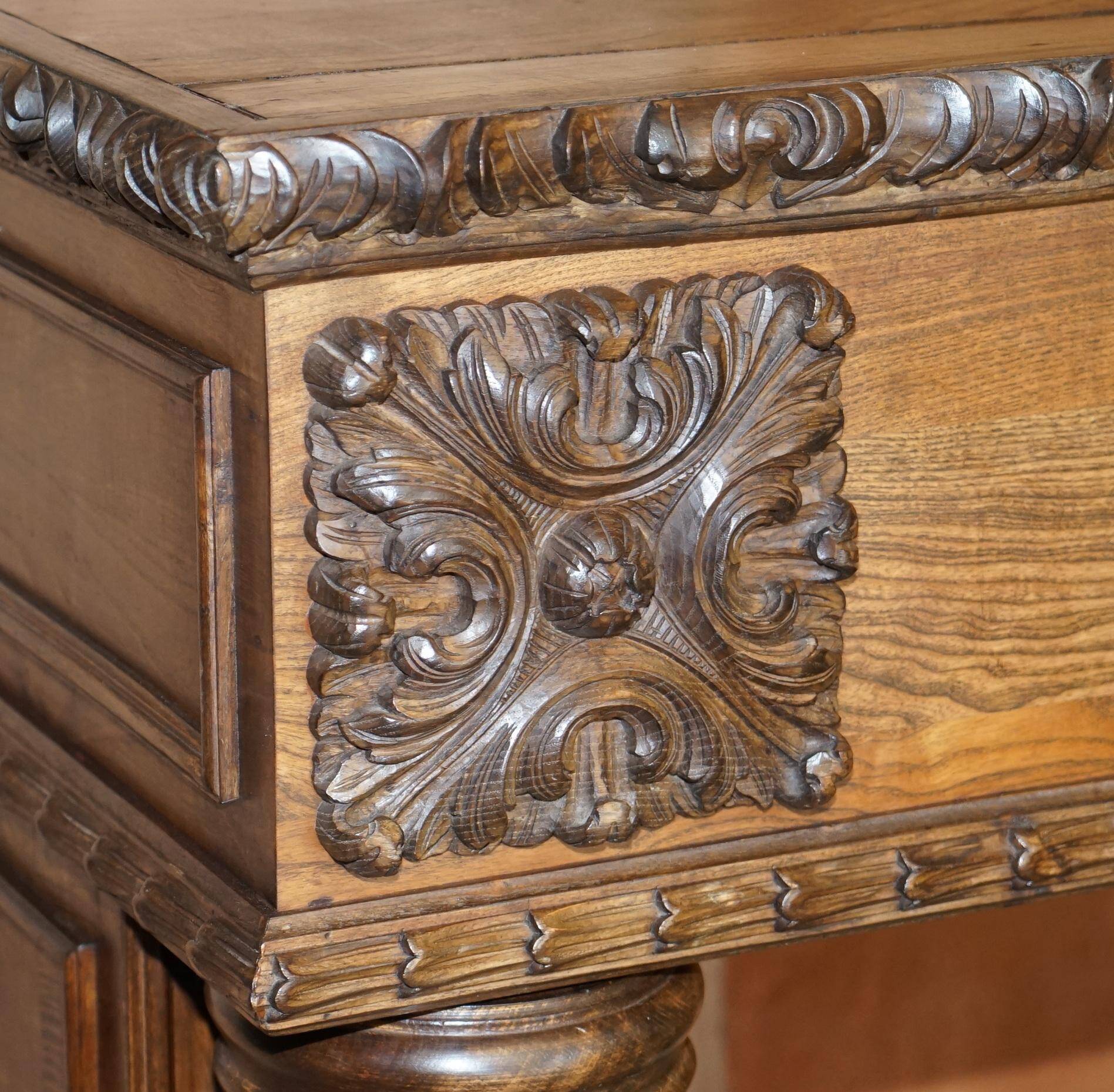 Antique fireplace from around 1880 in solid hand-carved elm with openwork columns.