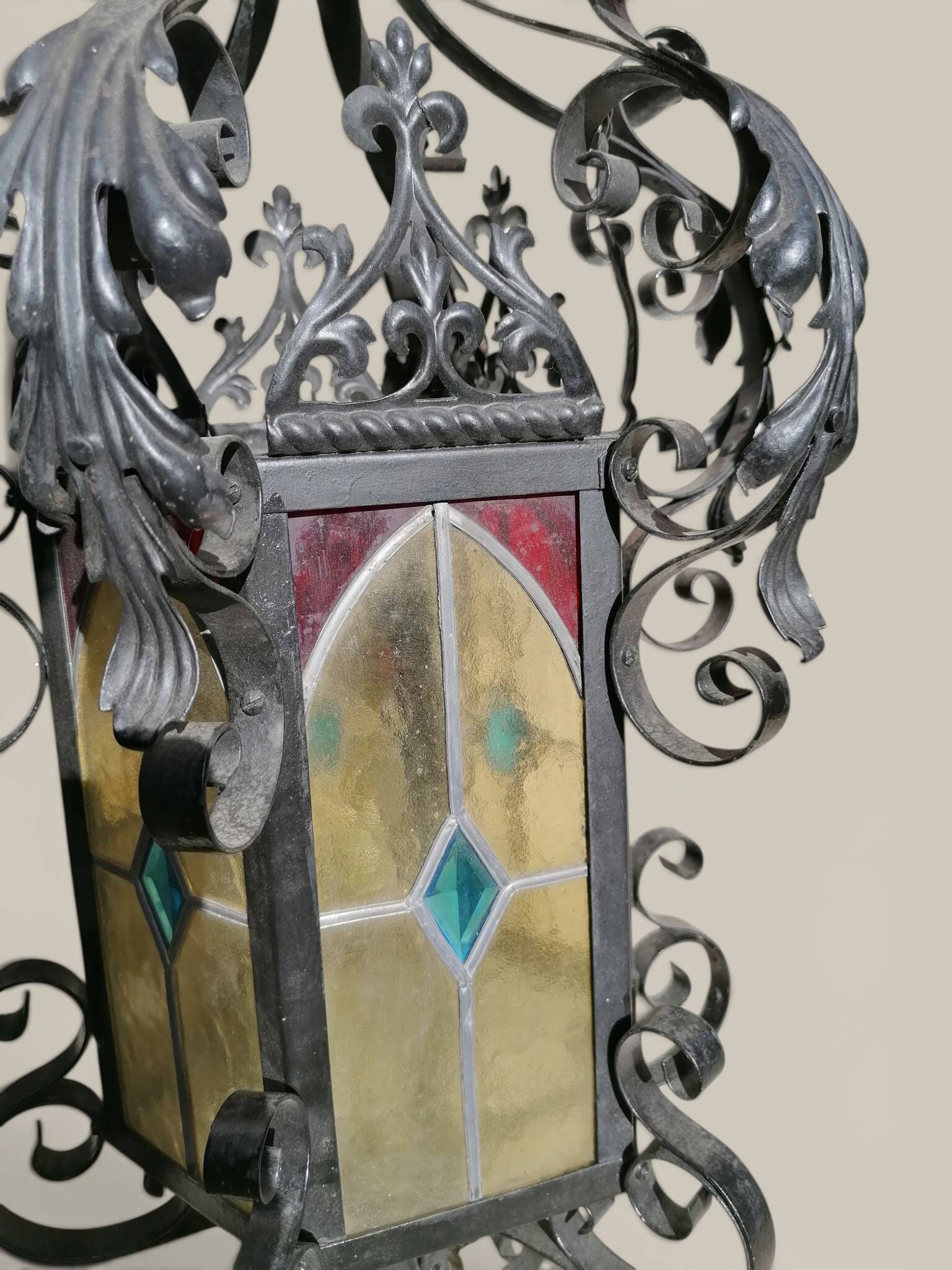Black wrought iron lantern with stained glass. Medieval, Gothic decoration.