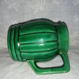 Old green pitcher in dabbling
