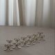 Set of six silver-plated ribbon-shaped knife rests. 20th century