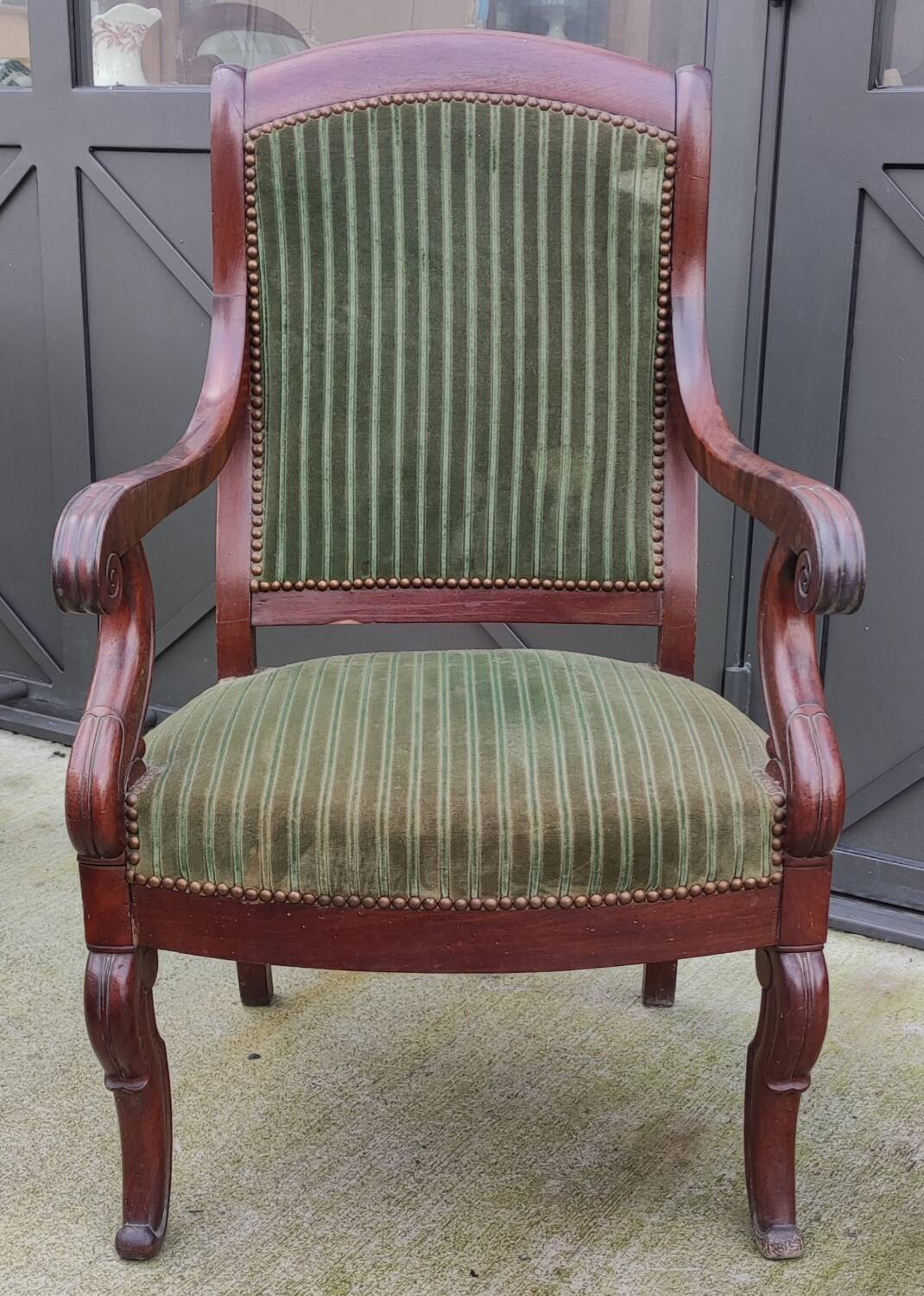 Old green velvet armchair