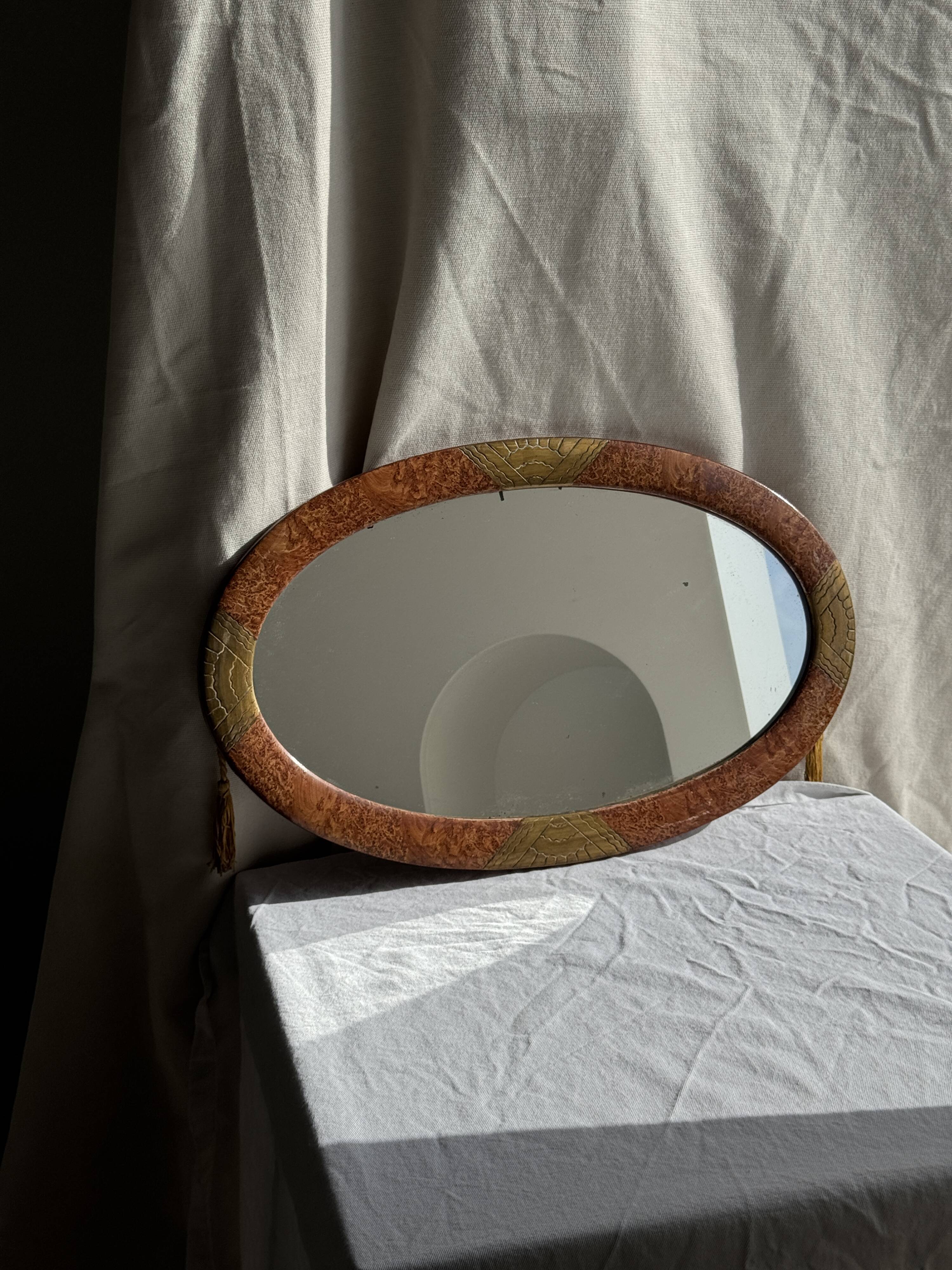 Small oval Art Deco mirror in brown and gold 33x54.