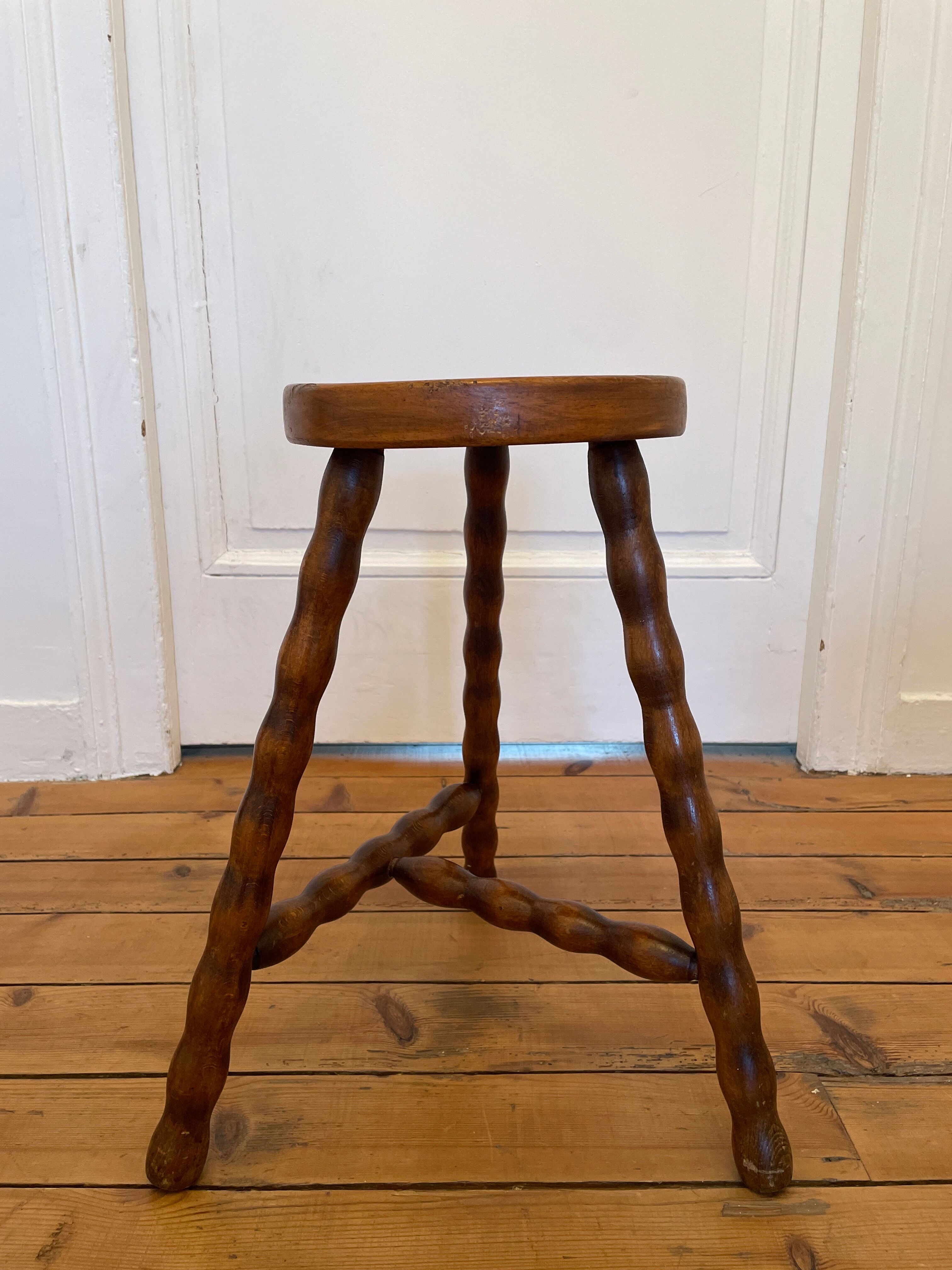 Old wooden tripod stool