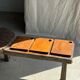 Small rectangular teak monoxyle cutting board with a circular handle.