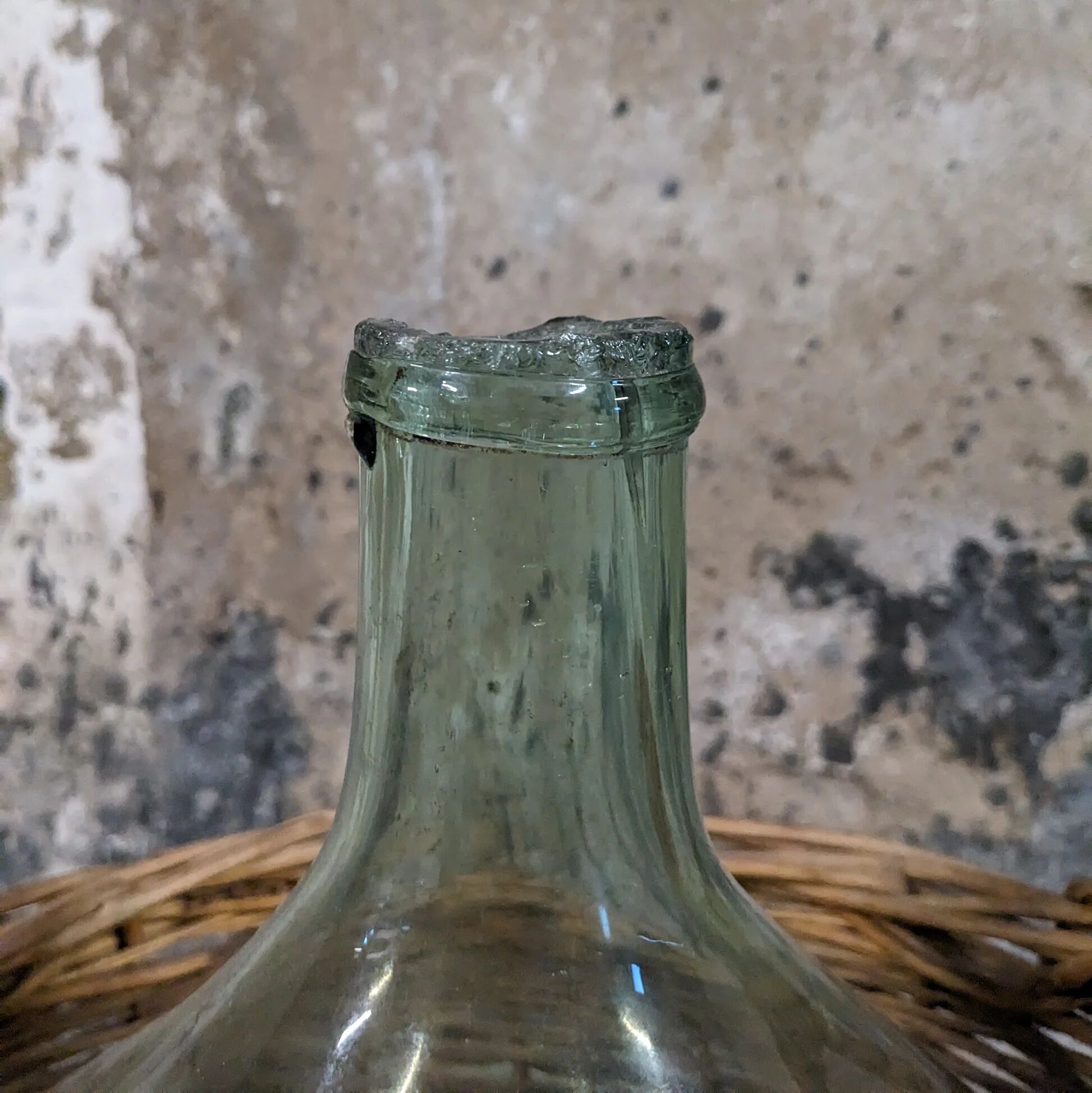 Demijohn in its wicker basket