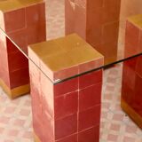 Modern coffee table in burgundy zellige with a tempered glass top.