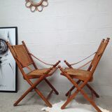 Pair of folding chairs in bamboo and caning, leather and brass
