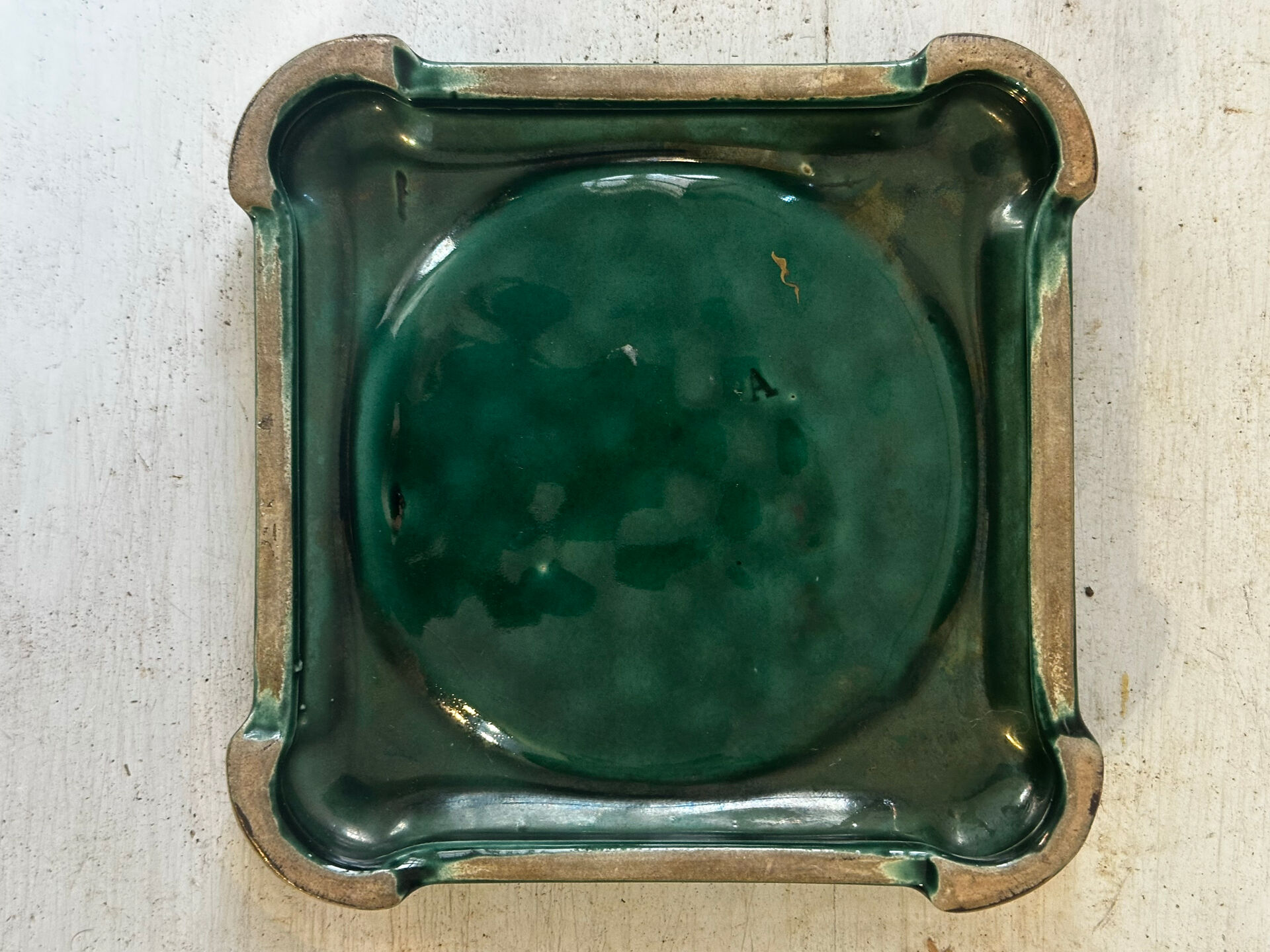 Art Deco bottle coaster in speckled green glazed ceramic and