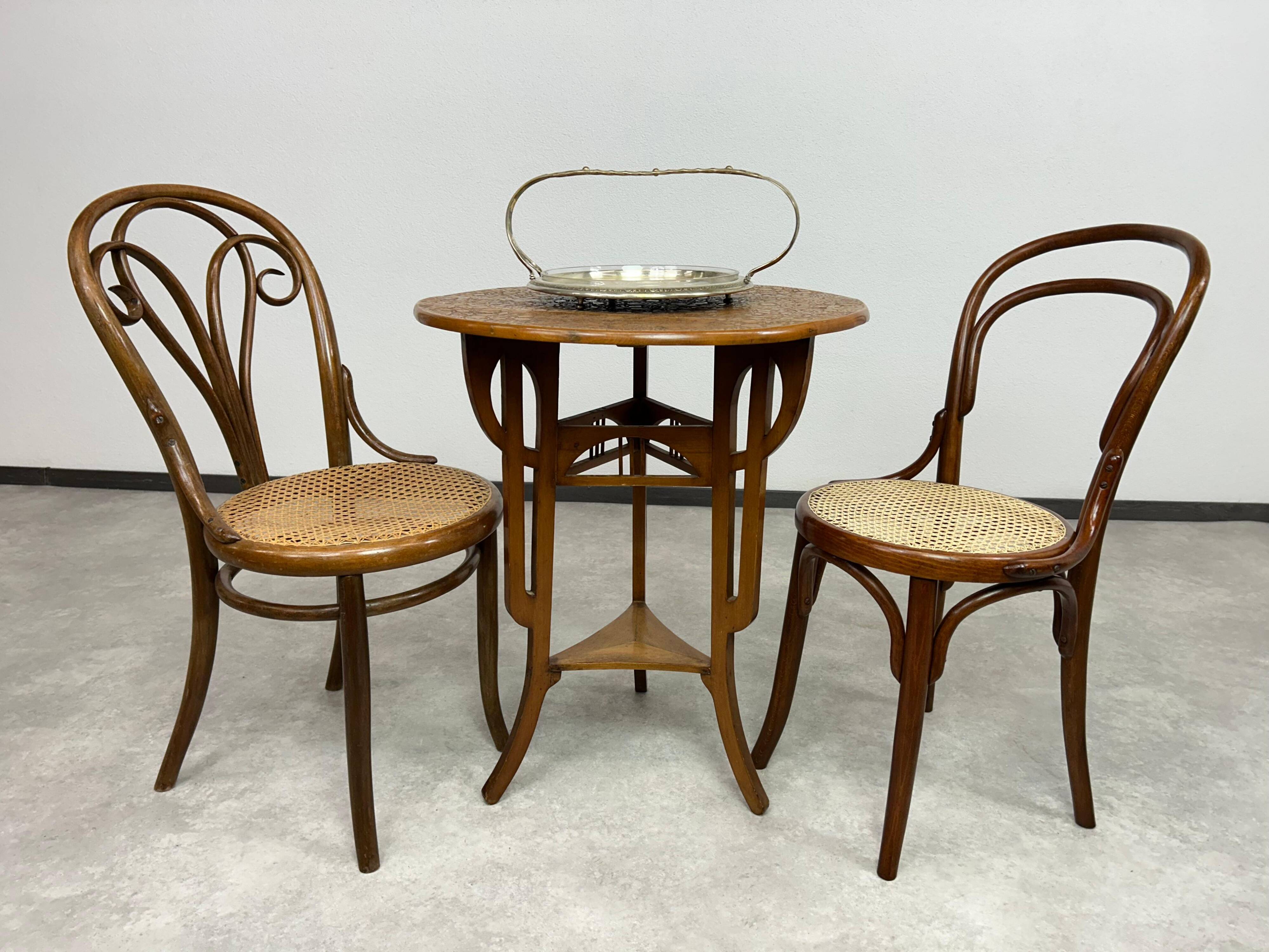 Round Art Nouveau coffee table with a sculpted top.