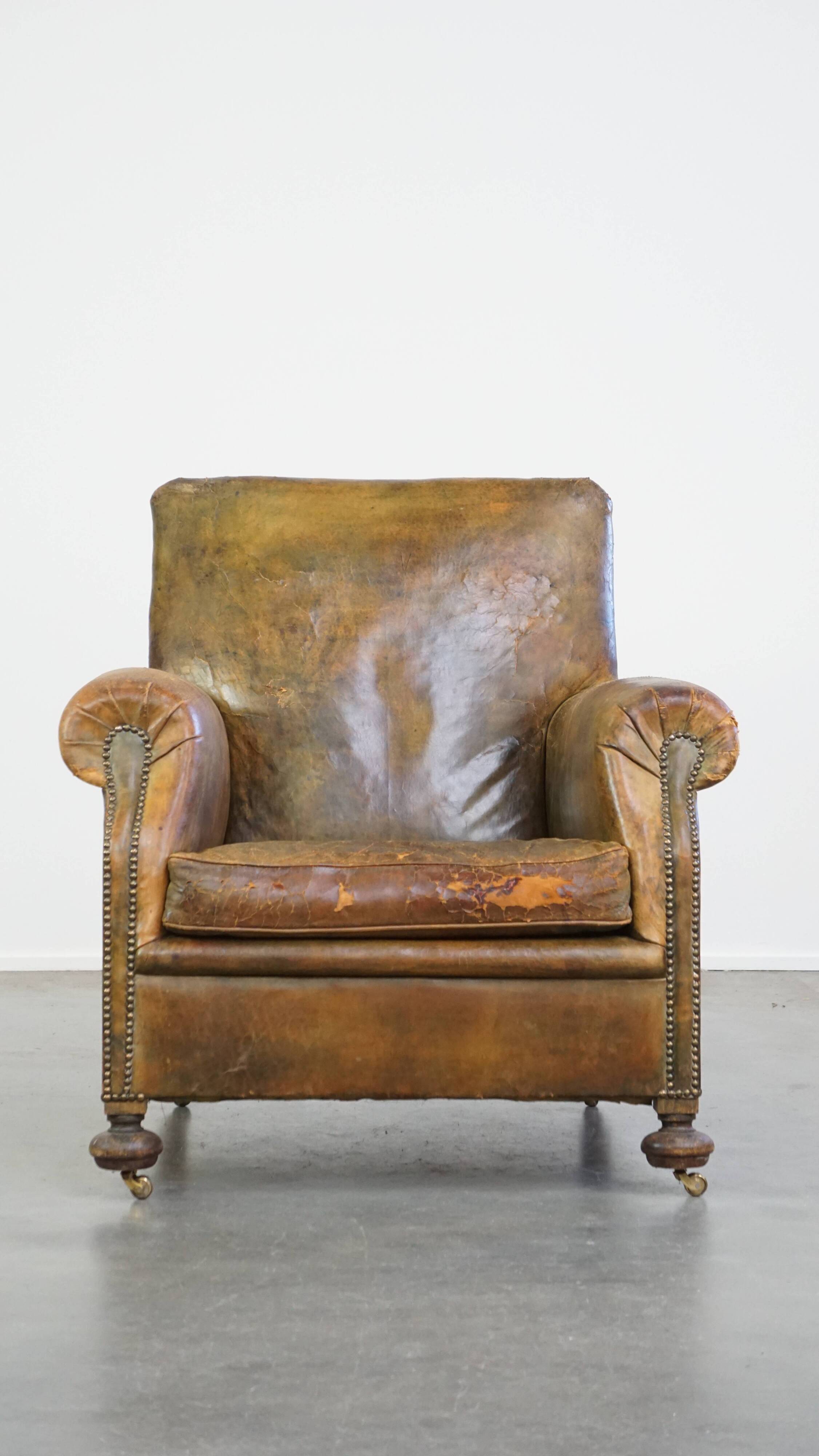 Green antique English cowhide leather armchair on wheels