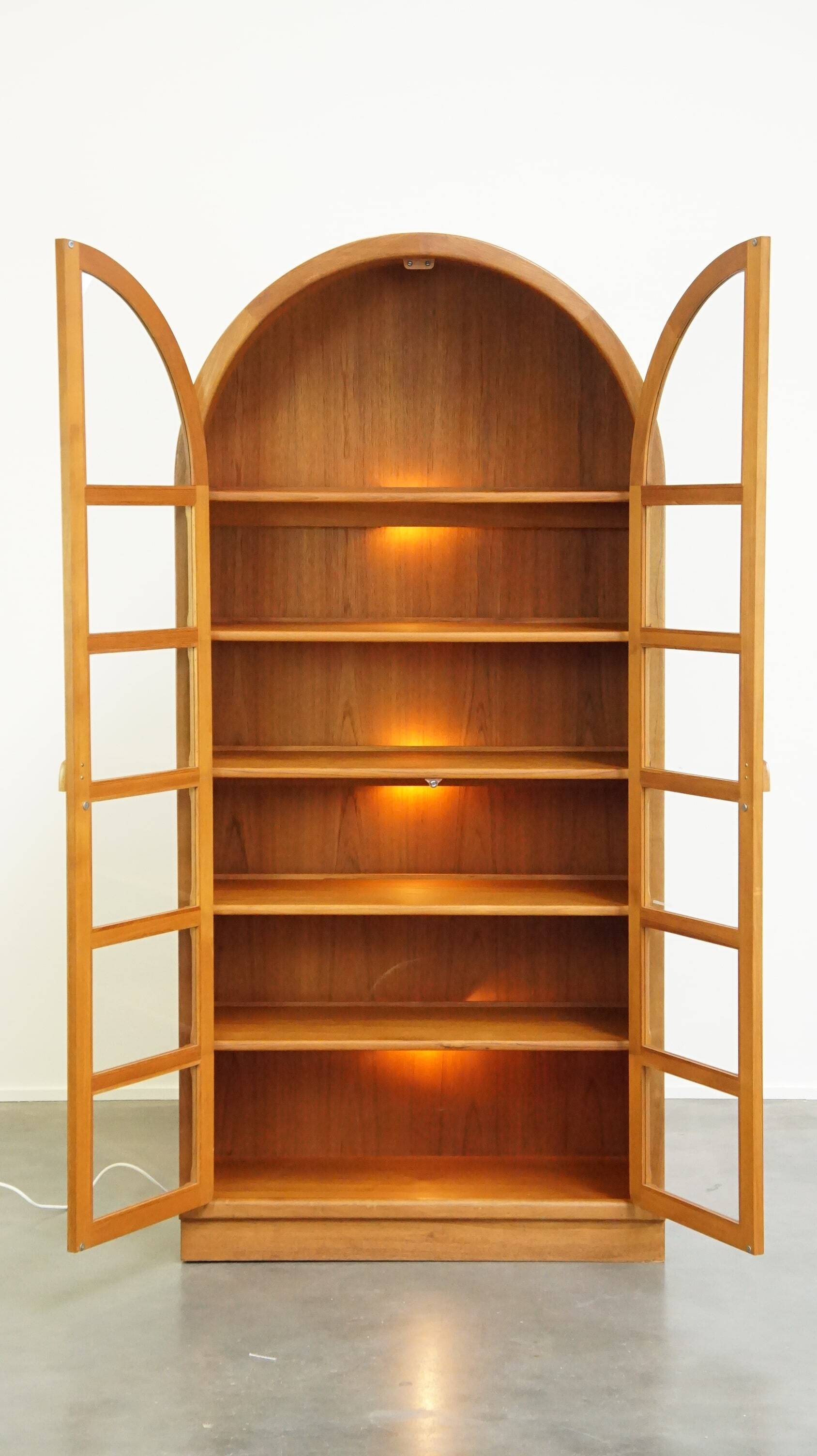 Elegant vintage Danish display cabinet with glass panels and atmospheric lighting
