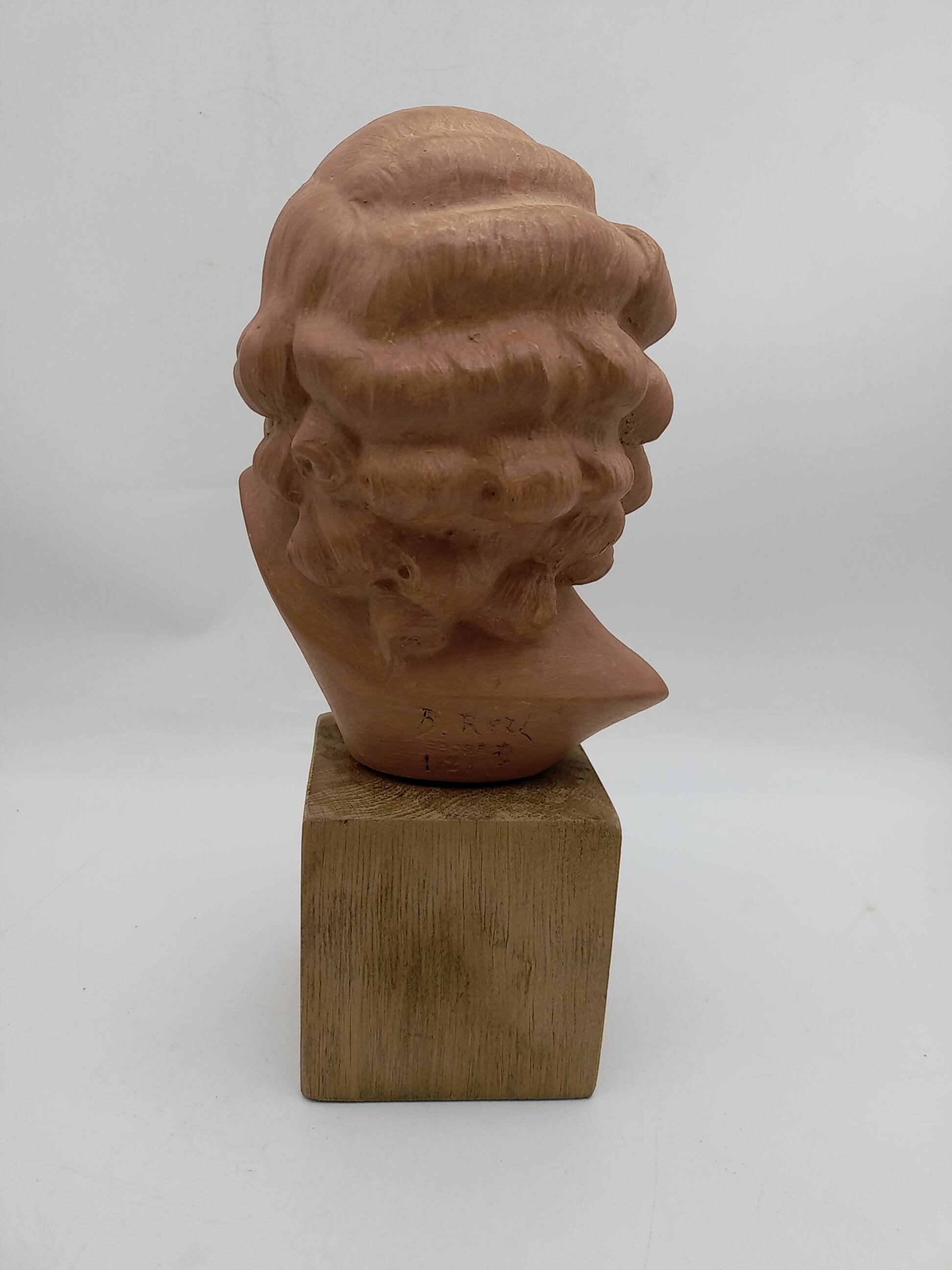 Bust young smiling girl. Circa 1900. Art Deco. Signed.
