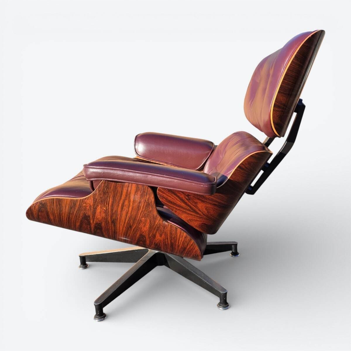 Original Eames lounge chair by Herman Miller in burgundy rosewood.