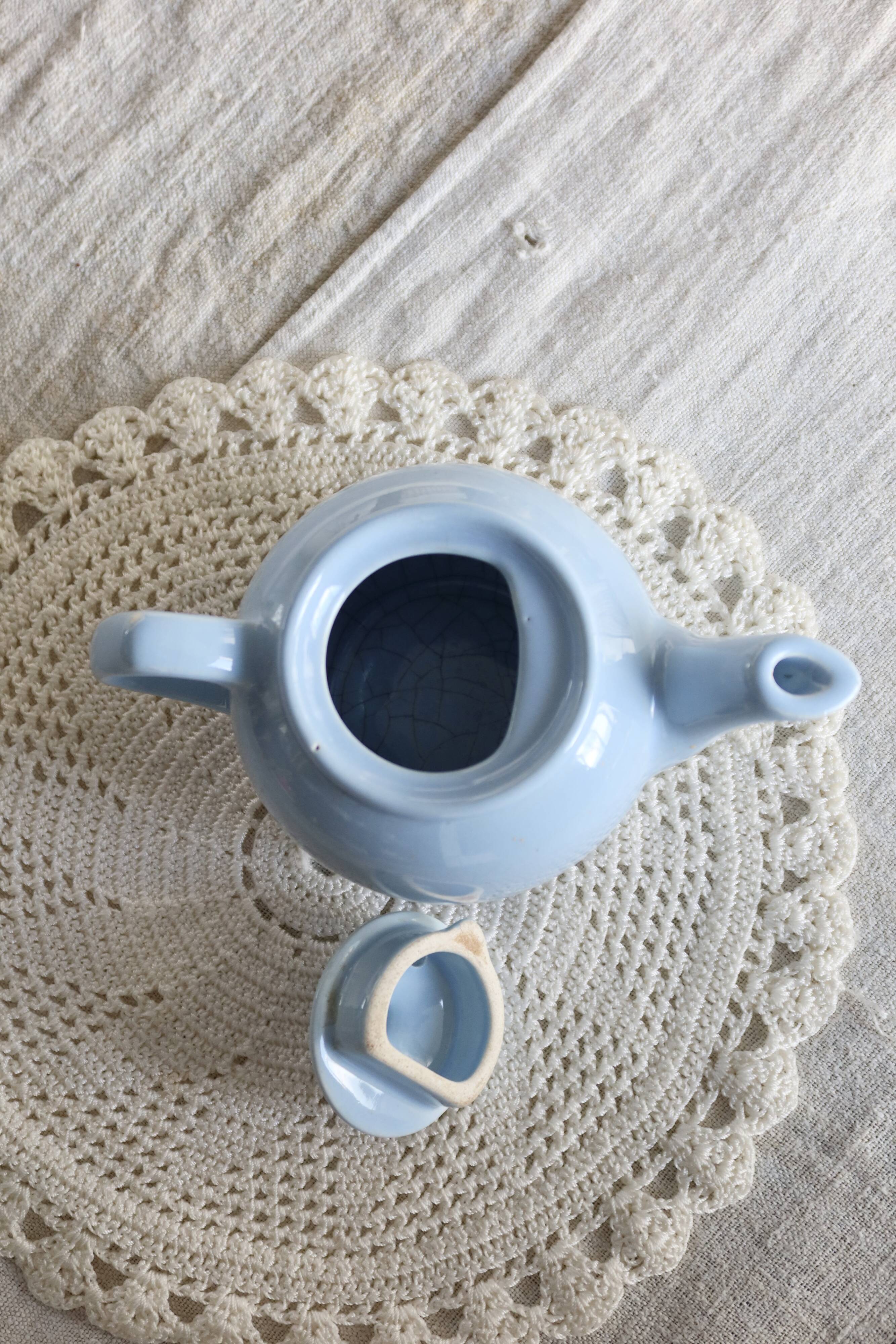Small vintage sky-blue earthenware teapot