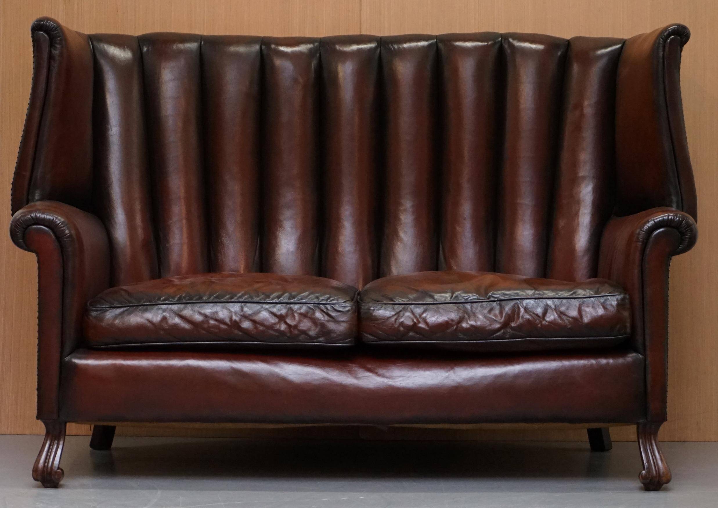 Victorian leather canapé and armchair, barrel back, circa 1860, restored.