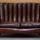 Victorian leather canapé and armchair, barrel back, circa 1860, restored.
