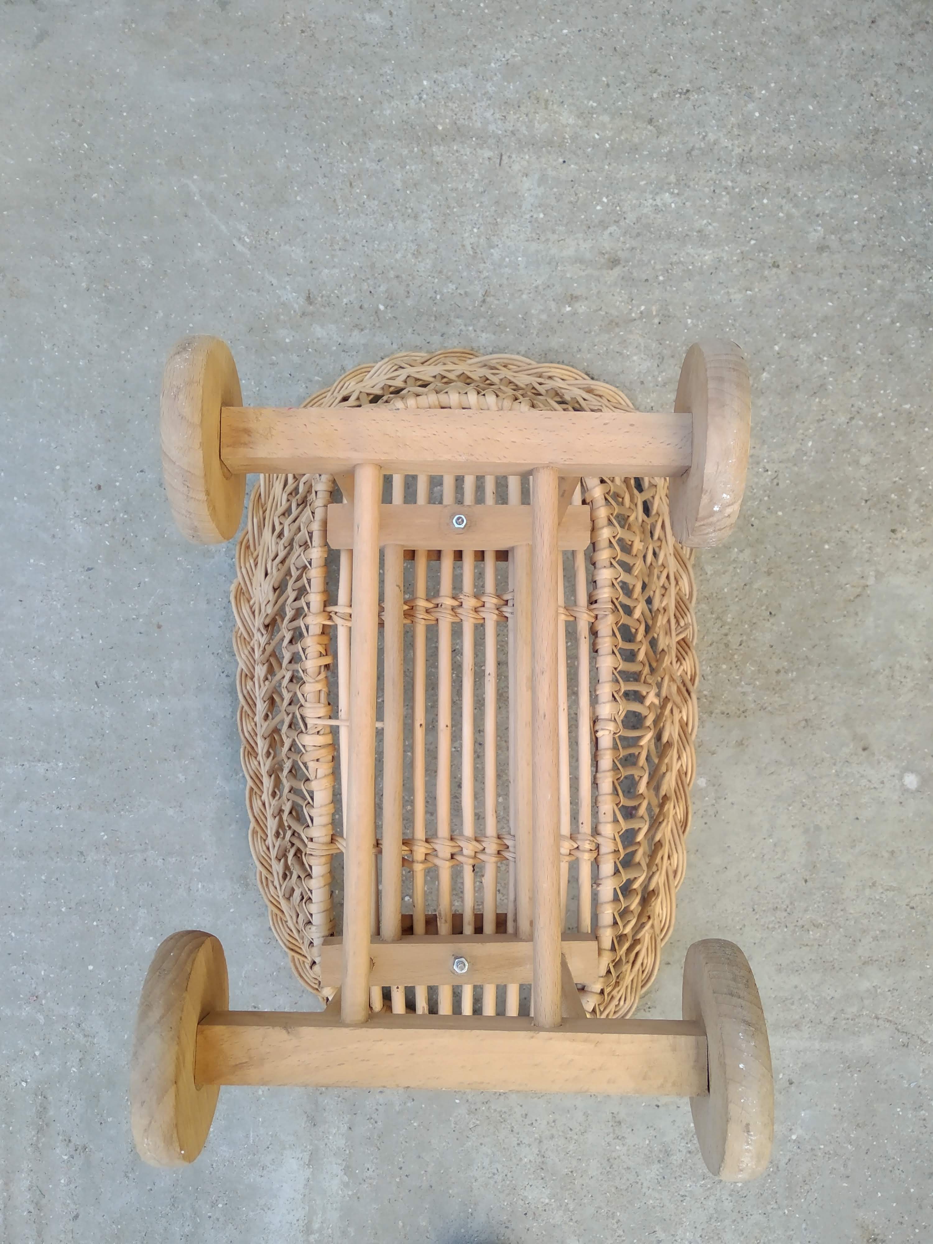 Rattan cradle for doll on vintage wheels
