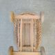 Rattan cradle for doll on vintage wheels