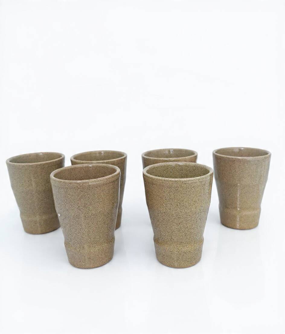 Set of 6 stoneware cups signed Cermer. Beige speckled, matte granular finish.
