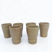 Set of 6 stoneware cups signed Cermer. Beige speckled, matte granular finish.