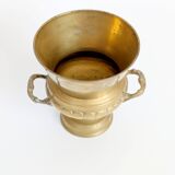Vintage brass cache-pot on a stand with handles, classic decor.